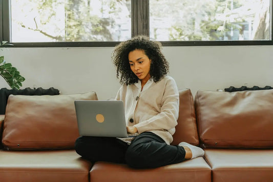 a woman using a laptop to purchase CBD