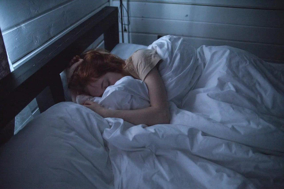 A woman with leg pain lying down rubbing her knee