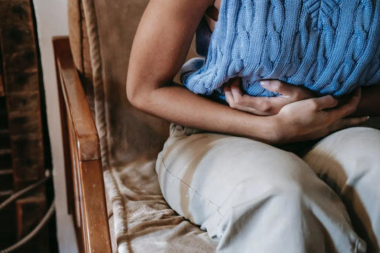 A woman suffering from stomach pain