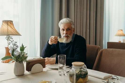 an elderly man drinking a CBD infused tea