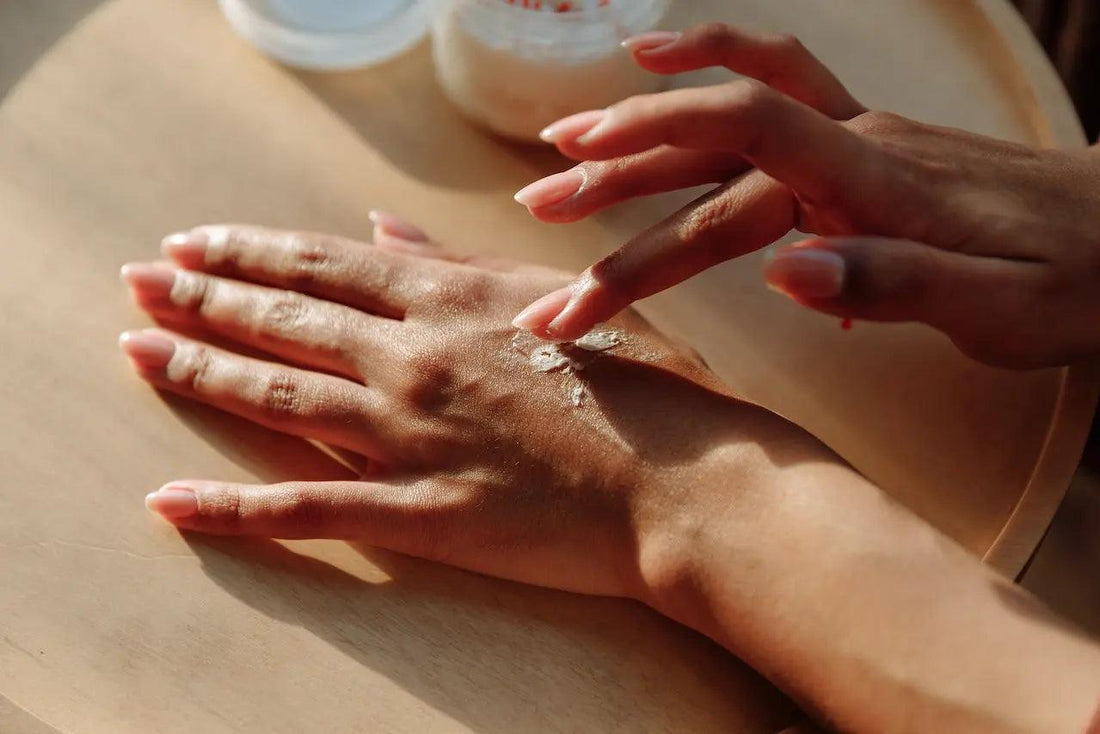 a close up of a woman applying CBD icy hot on her wrist