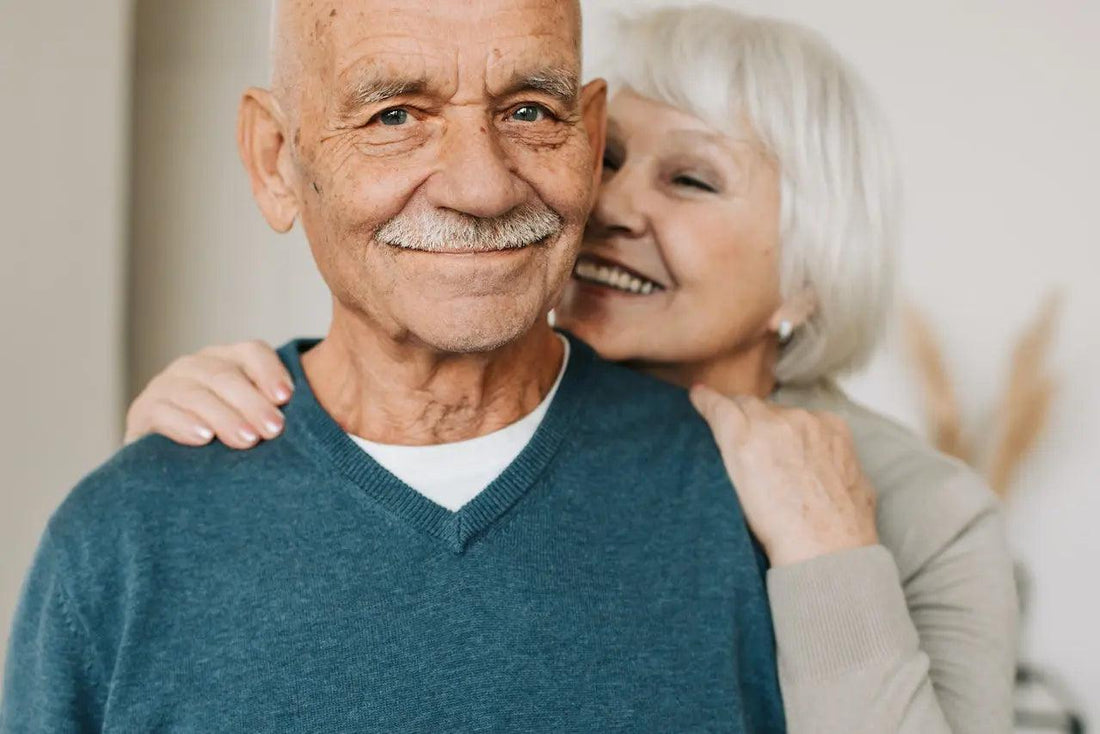 a lovely elderly couple smiling at the camera