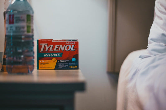 Tylenol next to a bed stand